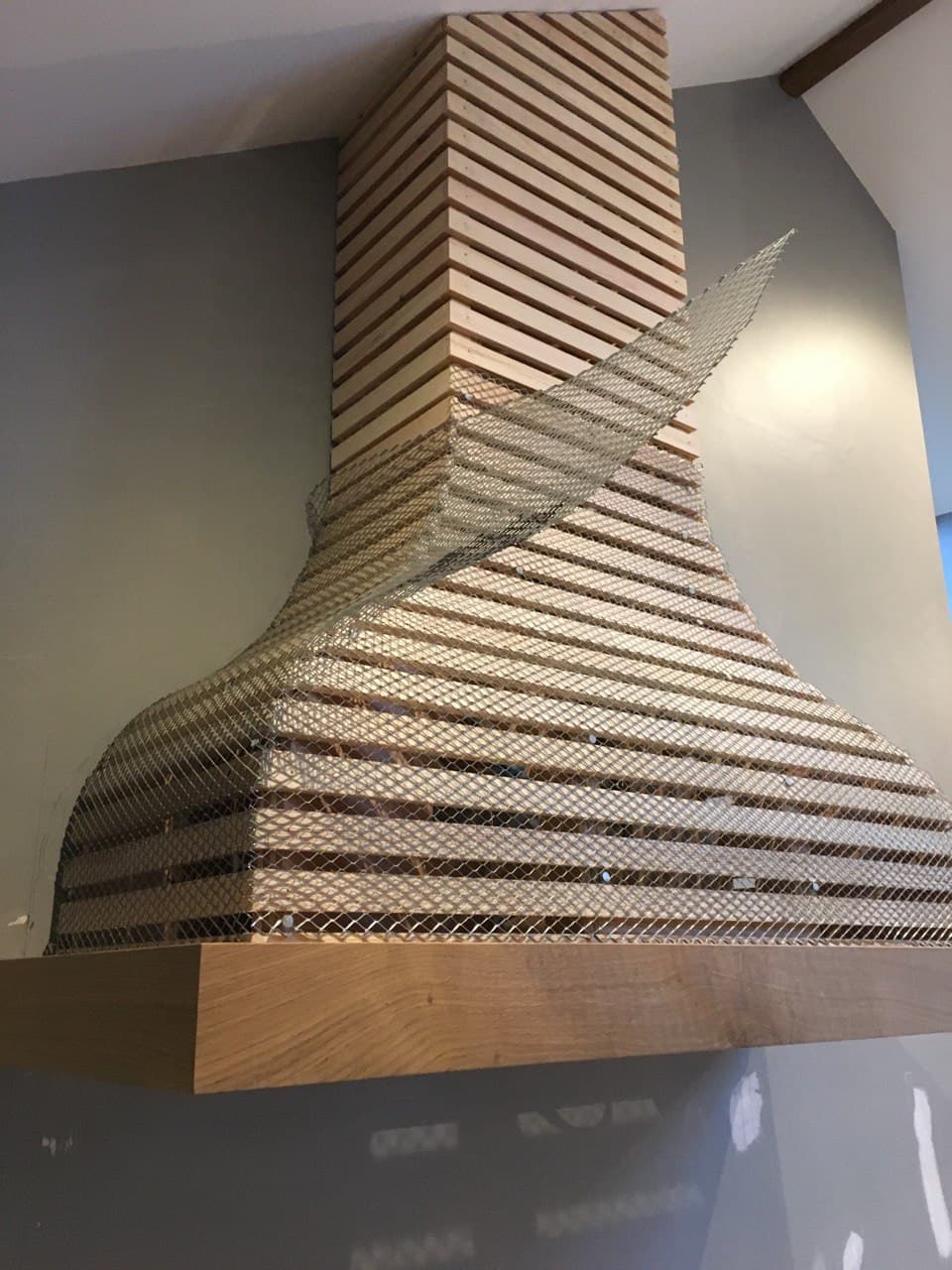 Timber lath and expanded metal mesh framework for bespoke chimney hood construction