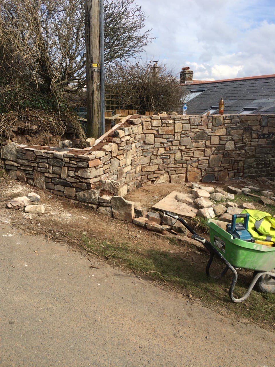 Natural stone boundary wall under construction using locally sourced stone in North Cornwall